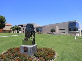 Grimm Hall at midday with Holy Spirit sculpture.